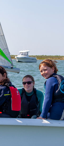 	a group of children in an RS quest sailing dinghy