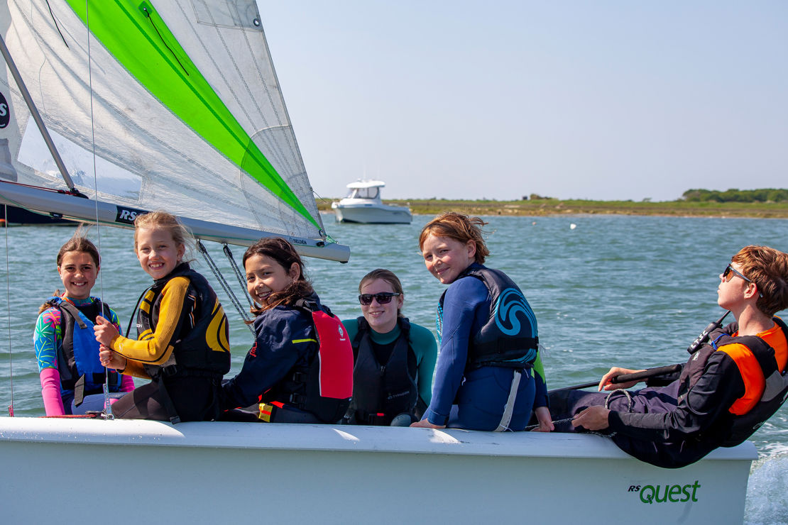 	a group of children in an RS quest sailing dinghy