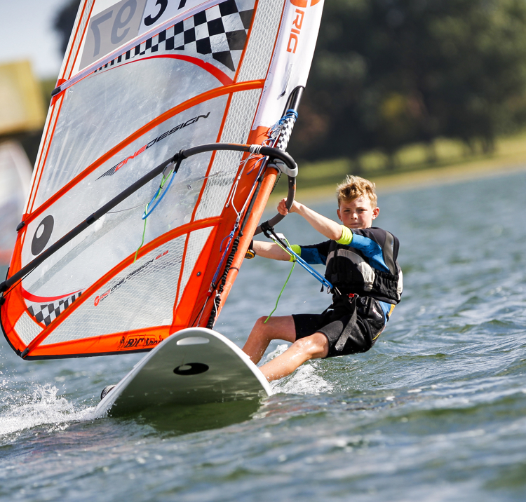Young Boy on Windsurfing Board at Oscar Shaw National Windsurfing Champs Rutland