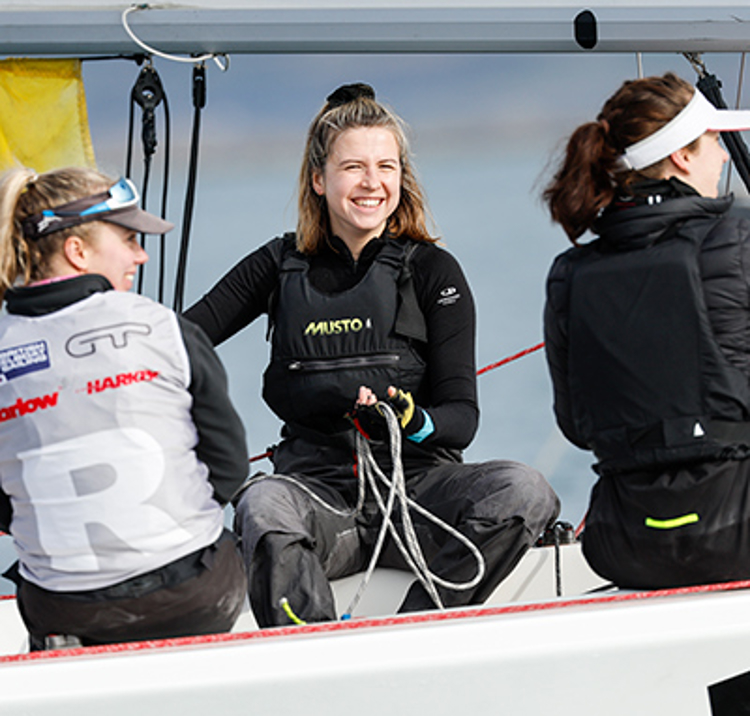 young people smiling on their dinghy