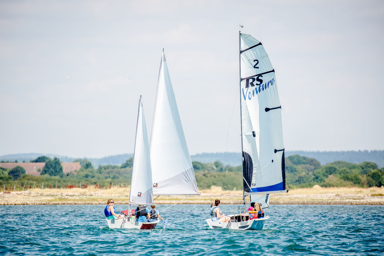 Families enjoying a summer afternoon on their dinghies