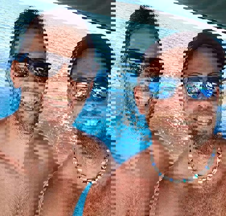 Selfie of Tom and Peter smiling on their boat