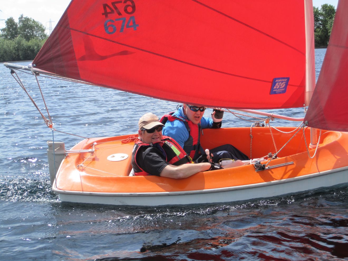 Two gentleman sailing in a dinghy