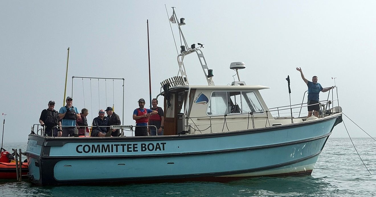Volunteers enjoying helping out on the committee boat at the Welsh Youth & Junior Championships