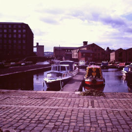 Sepia image of canal boats docked on a lake