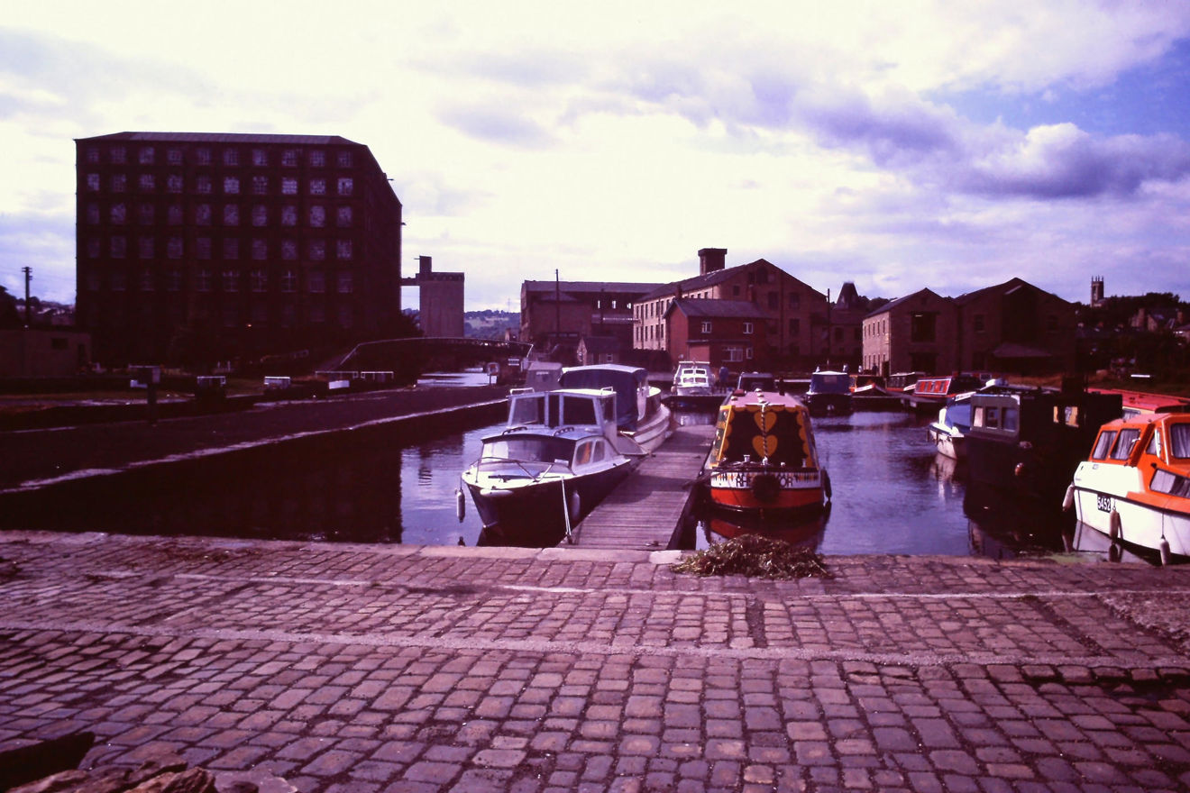 Sepia image of canal boats docked on a lake