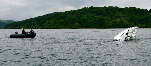 wide shot of keelboat recovery during capsize