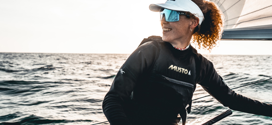 A member of the British Sailing Squad on a dinghy wearing Musto apparel