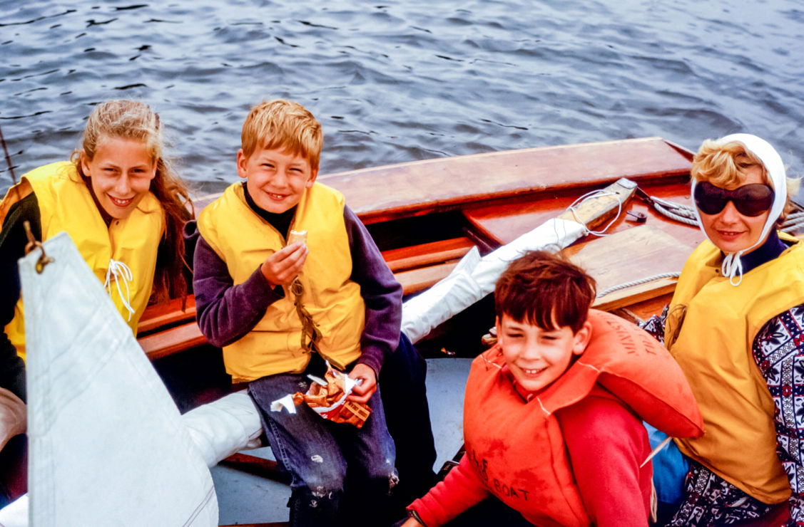 Children laughing and smiling on a small dinghy 