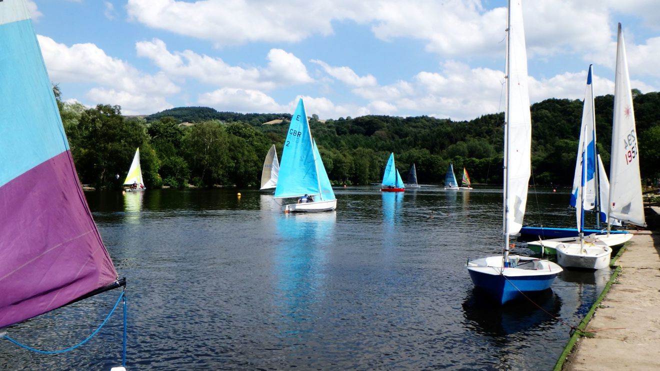 	An image of boats sailing and few of them staying still by the shore