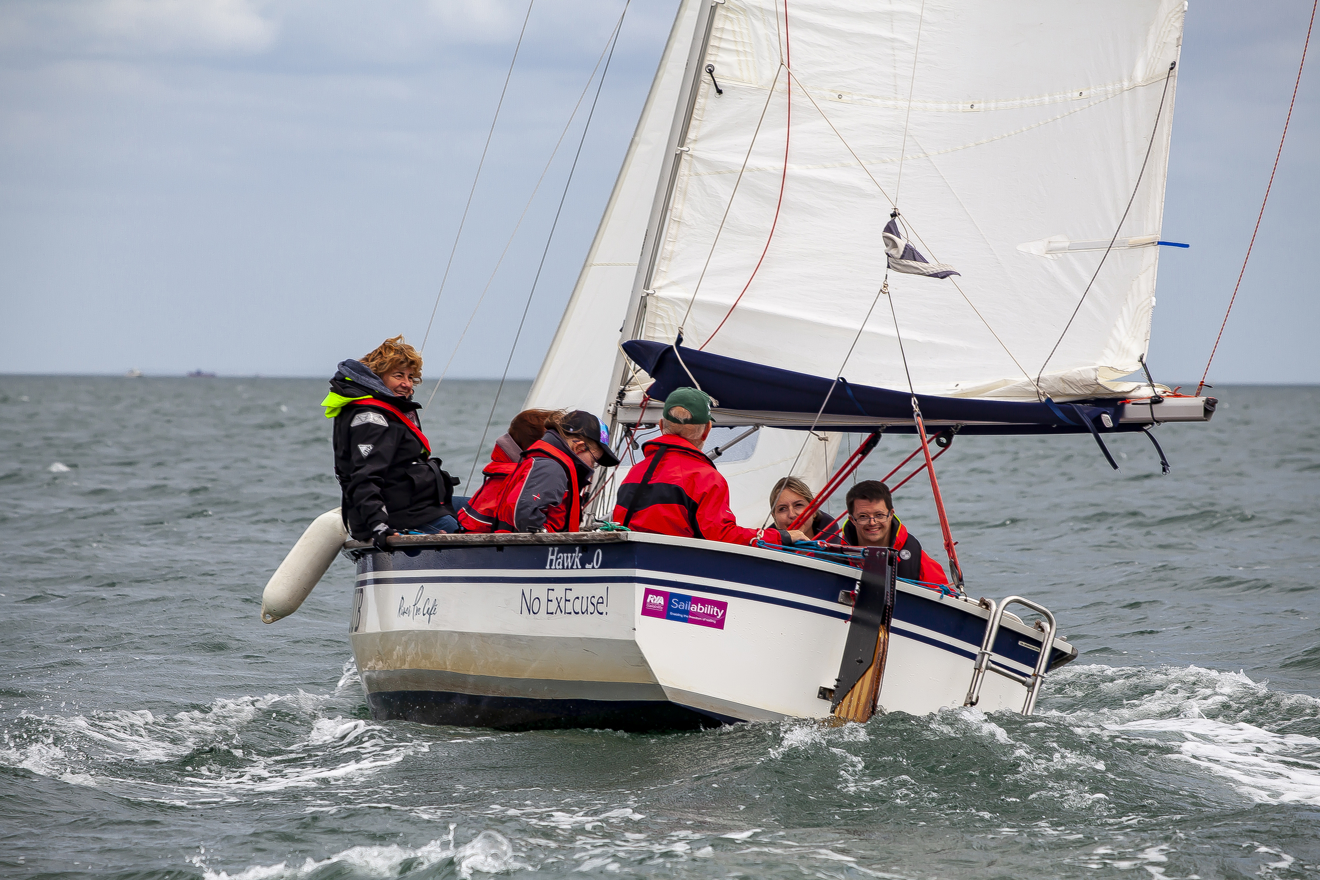An image of people enjoying the boating with smiles on their face