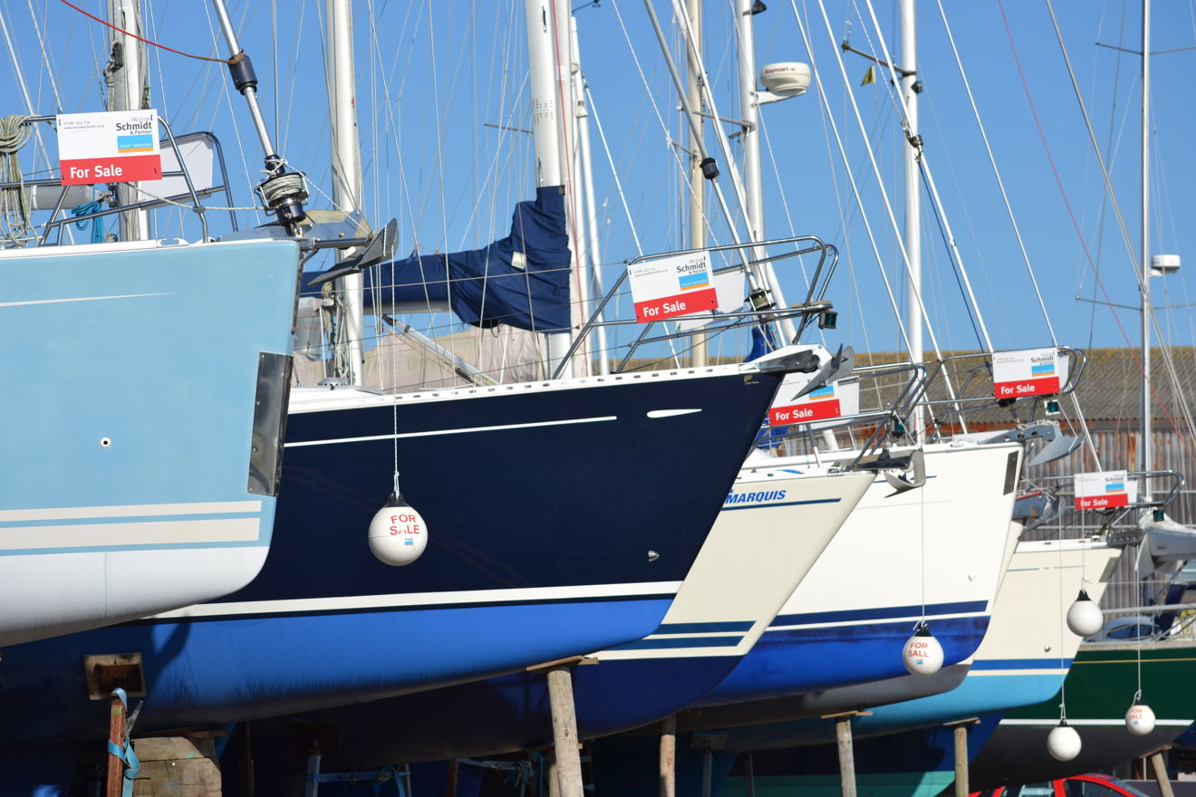 Lots of yachts for sale all in a line on the shore