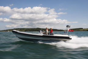 Two women and helm in fast, planing RIB