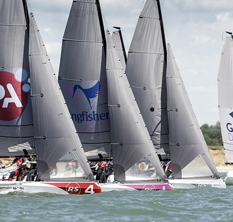 close keelboat racing along coastal course