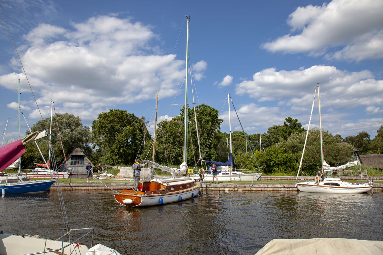 Sail boat moored up in front of a sailing club
