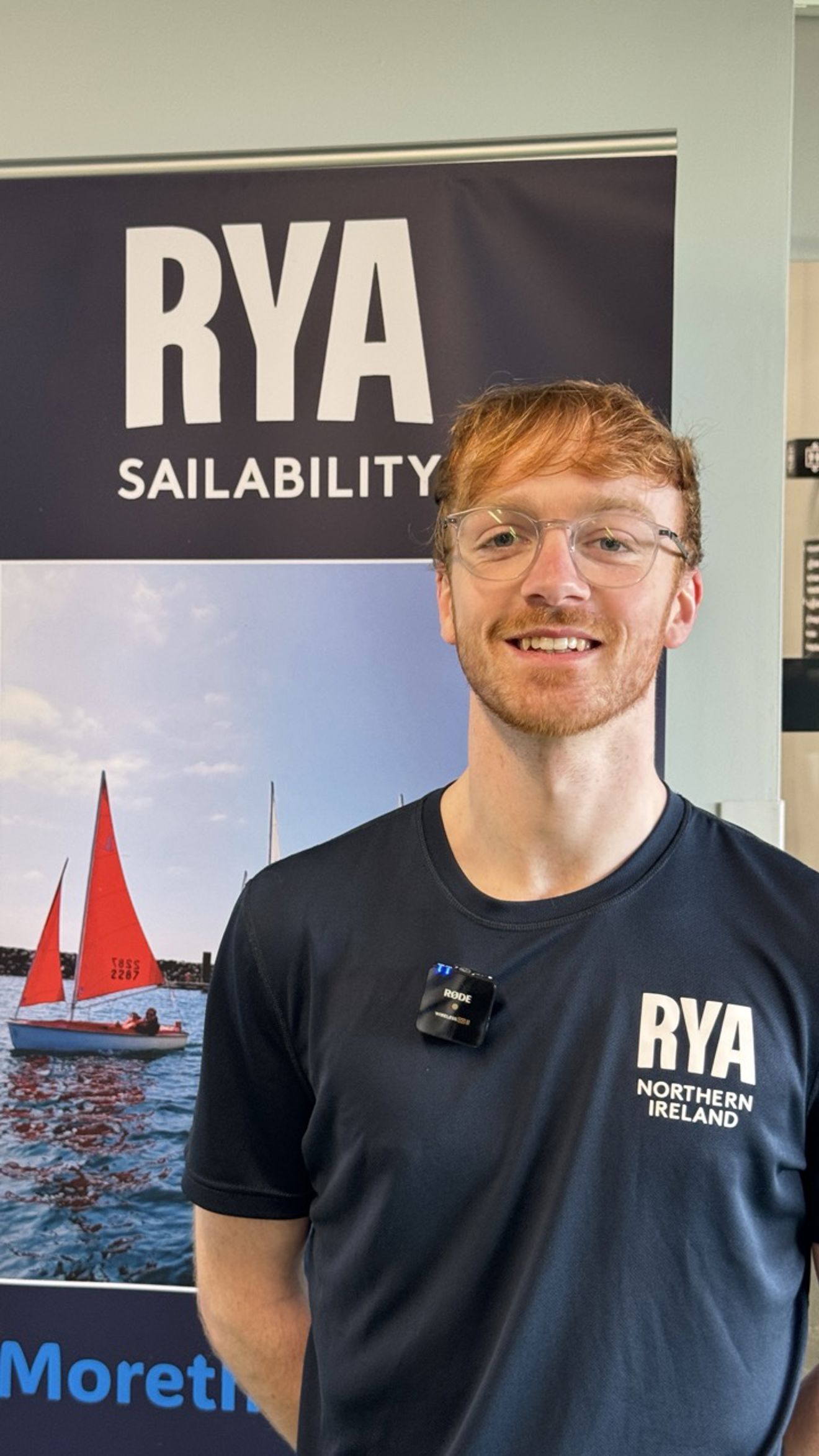 Oran standing in front of a sailability banner