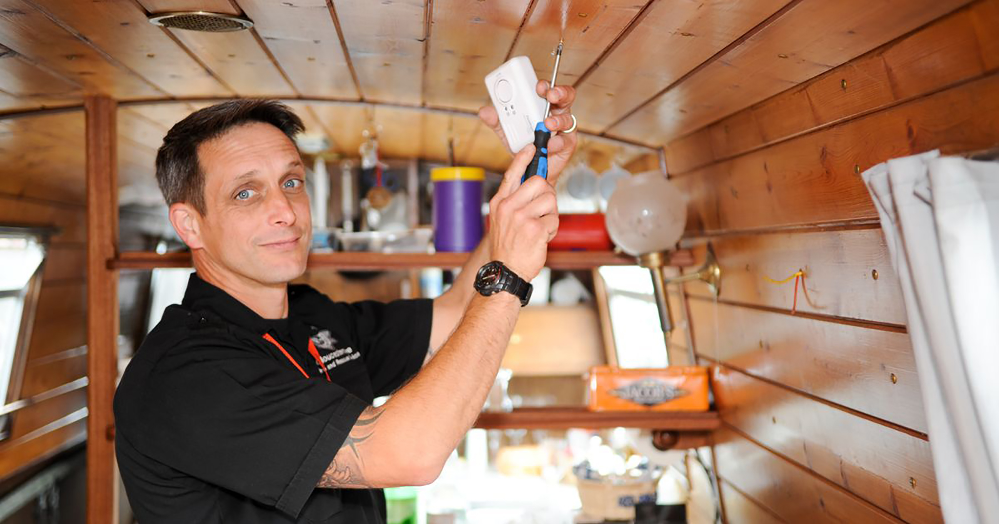 Mid shot of man fitting a carbon monoxide alarm