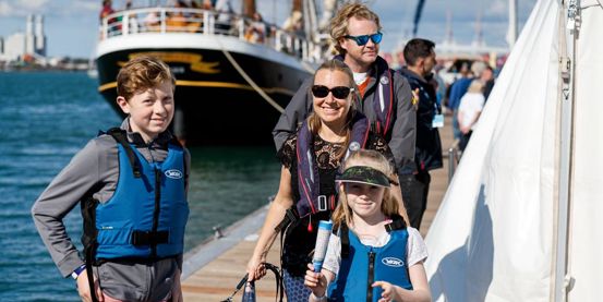 Family walking to boat at Southampton Boat Show