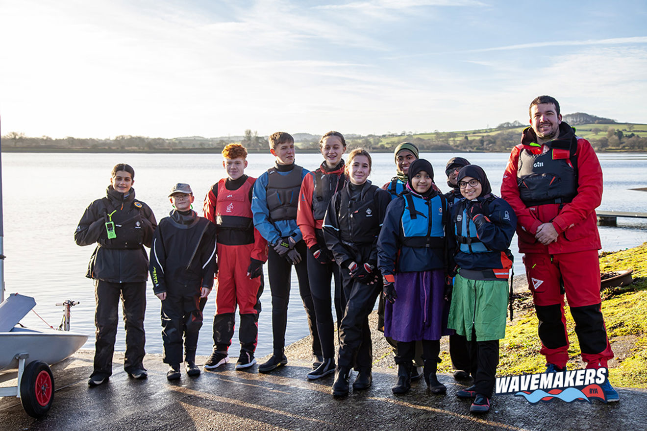 Group photograph of young sailors onshore with their instructor