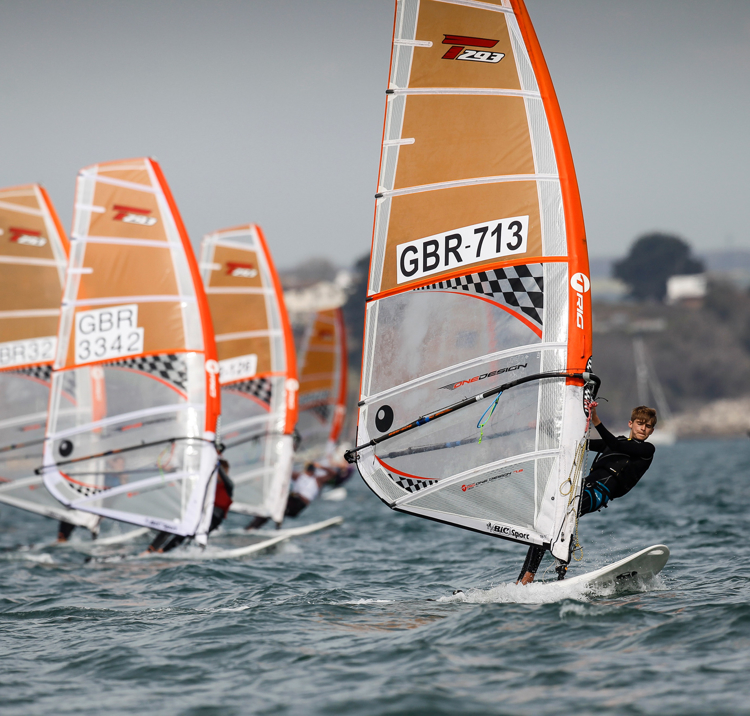 Children board racing in familiar waters
