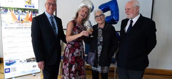 Group celebrating the 25th anniversary of Belfast Lough Sailability at a special event.