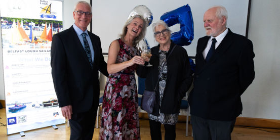 Group celebrating the 25th anniversary of Belfast Lough Sailability at a special event.