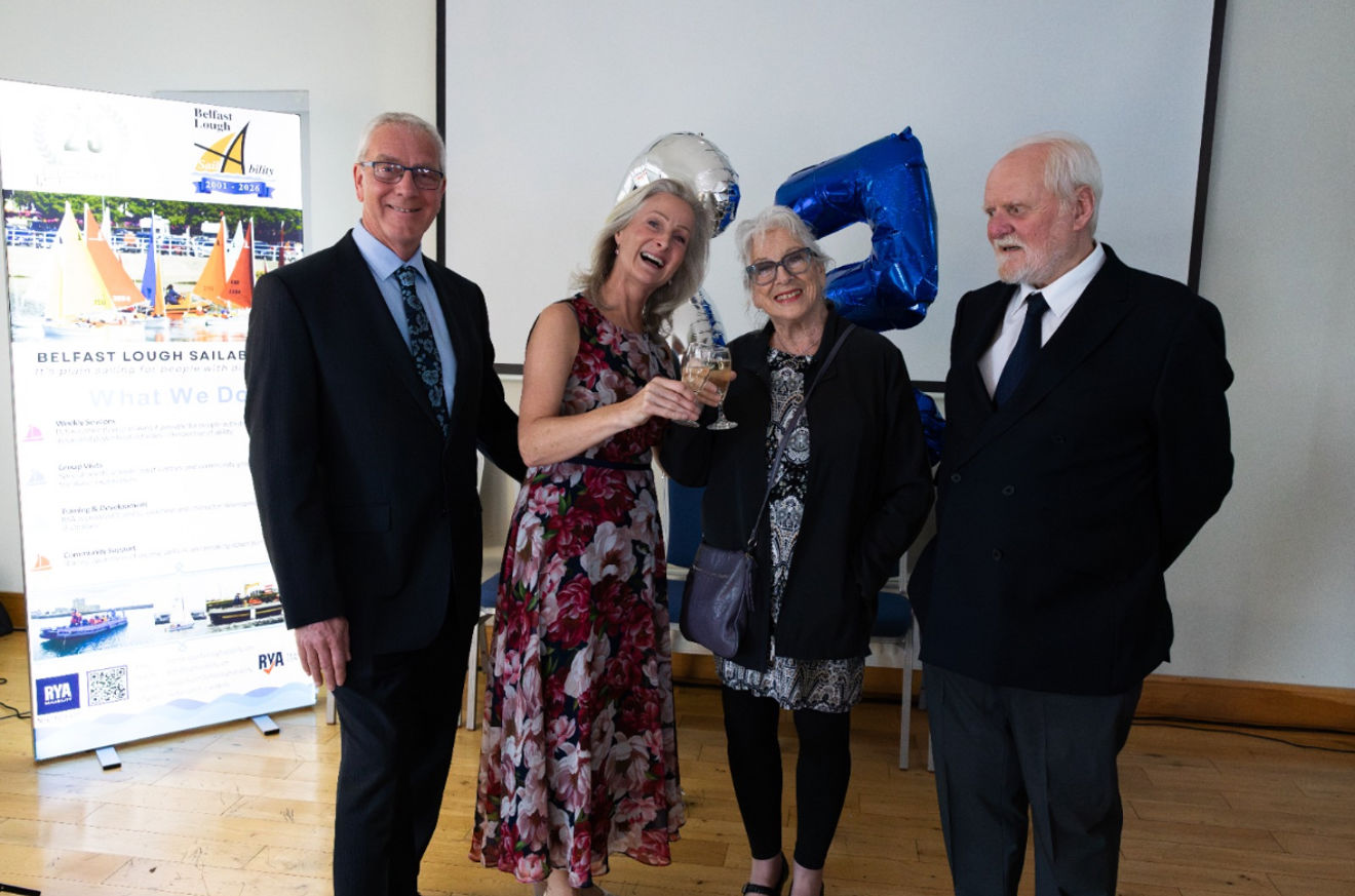Group celebrating the 25th anniversary of Belfast Lough Sailability at a special event.