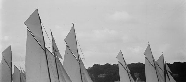 Black and white image of a fleet of sailiboats