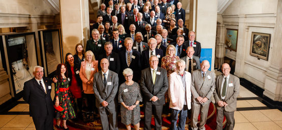 An image of all the volunteers standing by the staircase attending the RYA Volunteer Awards 2023