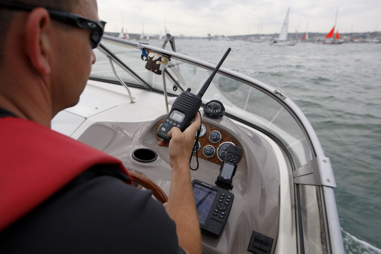 Man holding a vhf on his boat