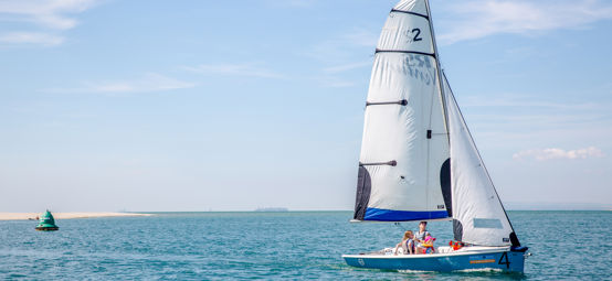 RS dinghy travelling through calm waters on a spring day