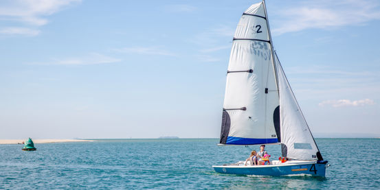 RS dinghy travelling through calm waters on a spring day