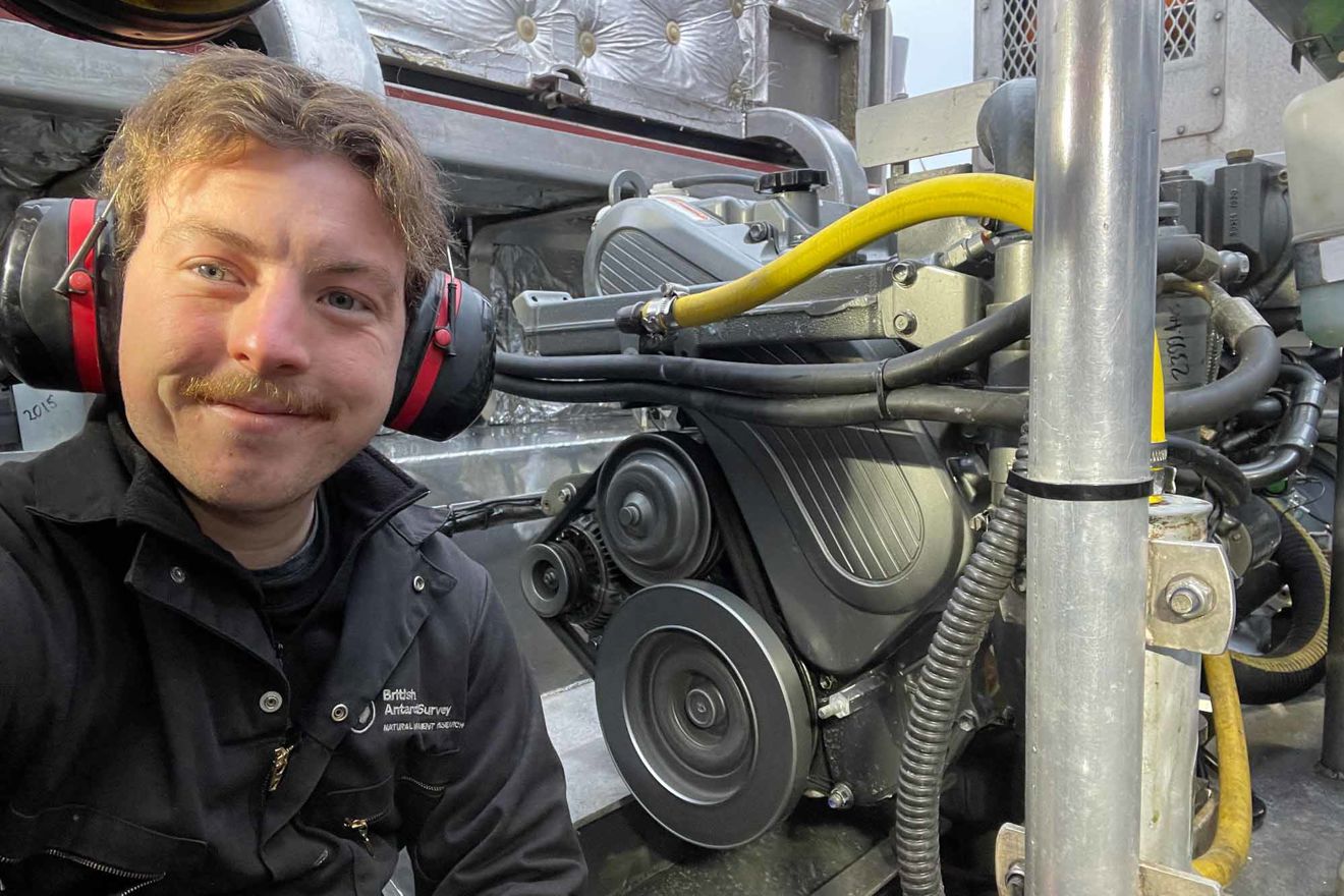 Louis Day Trinity House RYA Yachtmaster Scholarship sat in engine room wearing ear defenders