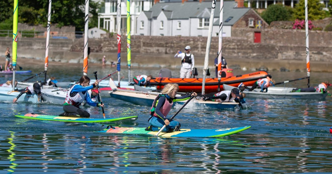 Regatta Fleet enjoying paddling races while waiting for wind (c) Ade Owens