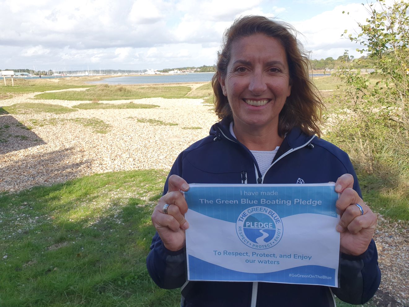 women holding green blue pledge certificate
