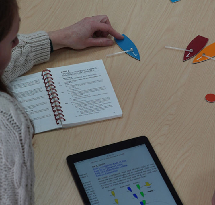 	A image of two young individuals discussing about the racing rules