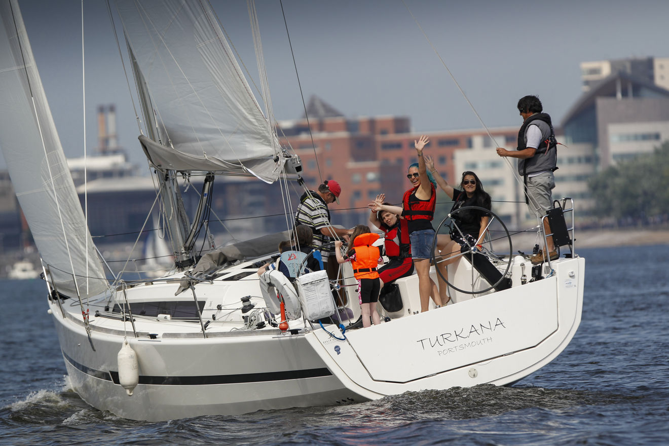 Yacht With Women Waving City Backdrop
