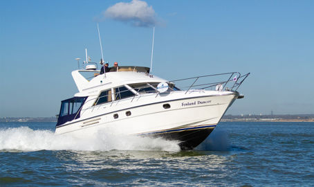 Motor cruiser travelling through blue waters