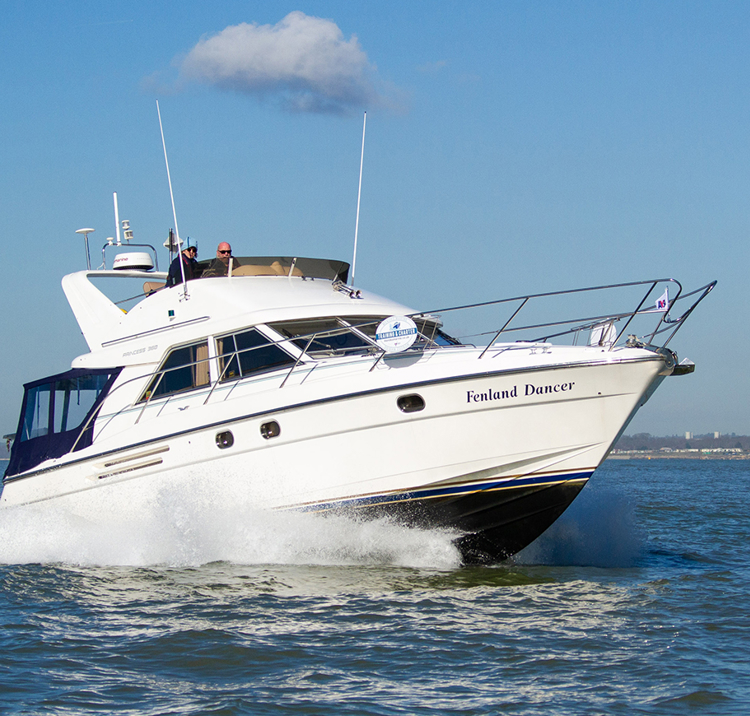 Motor cruiser travelling through blue waters