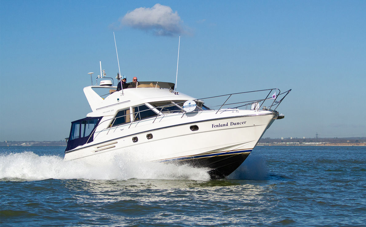 Motor cruiser travelling through blue waters