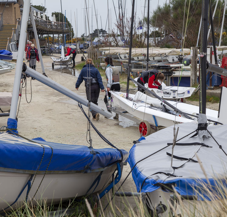 Instructors walking up sandy beach 