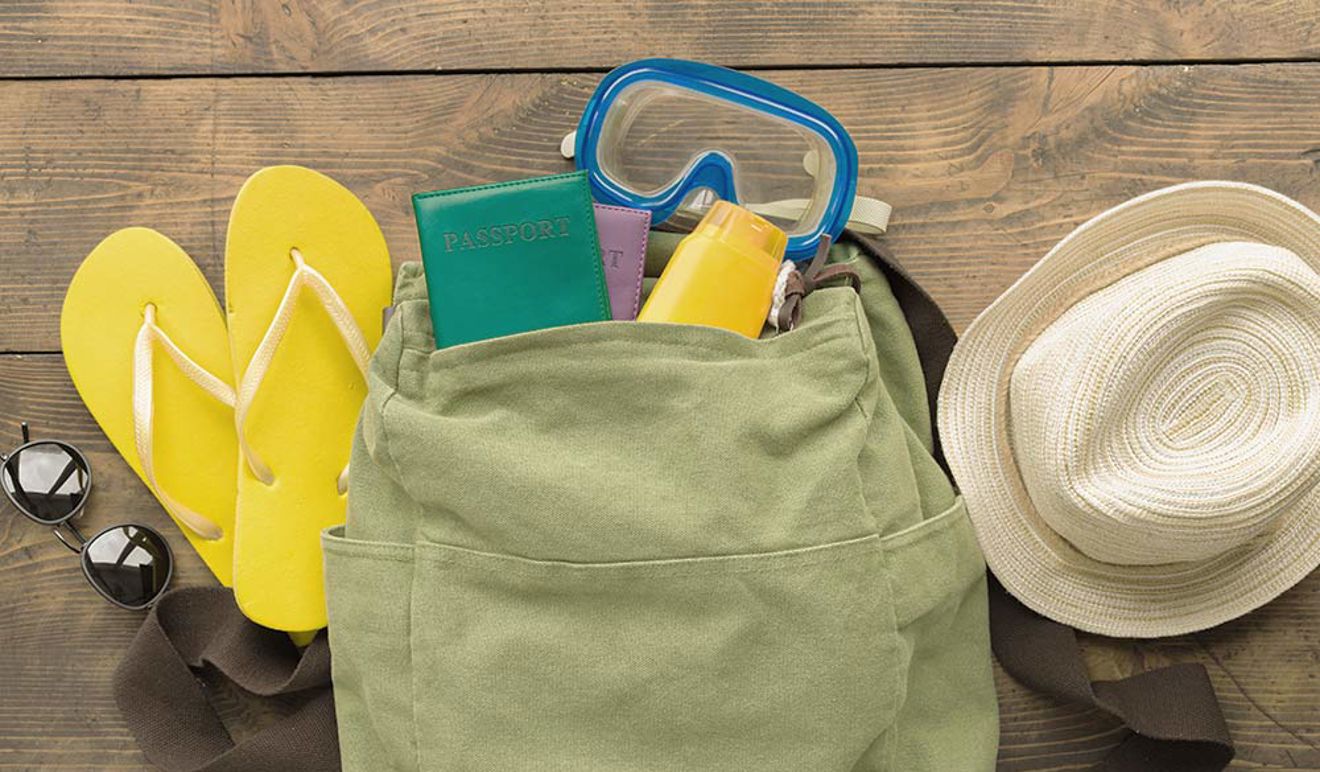 backpack including some holiday essentials like hat, flipflops and sun cream
