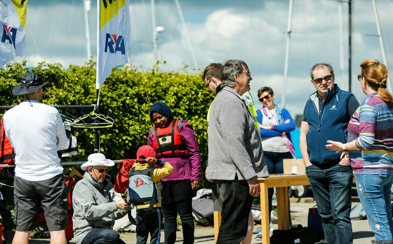 Busy scene of volunteers helping get people on the water