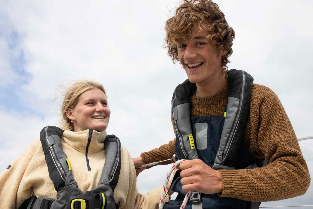 Mid shot of two smiling sailors wearing a spinlock jacket