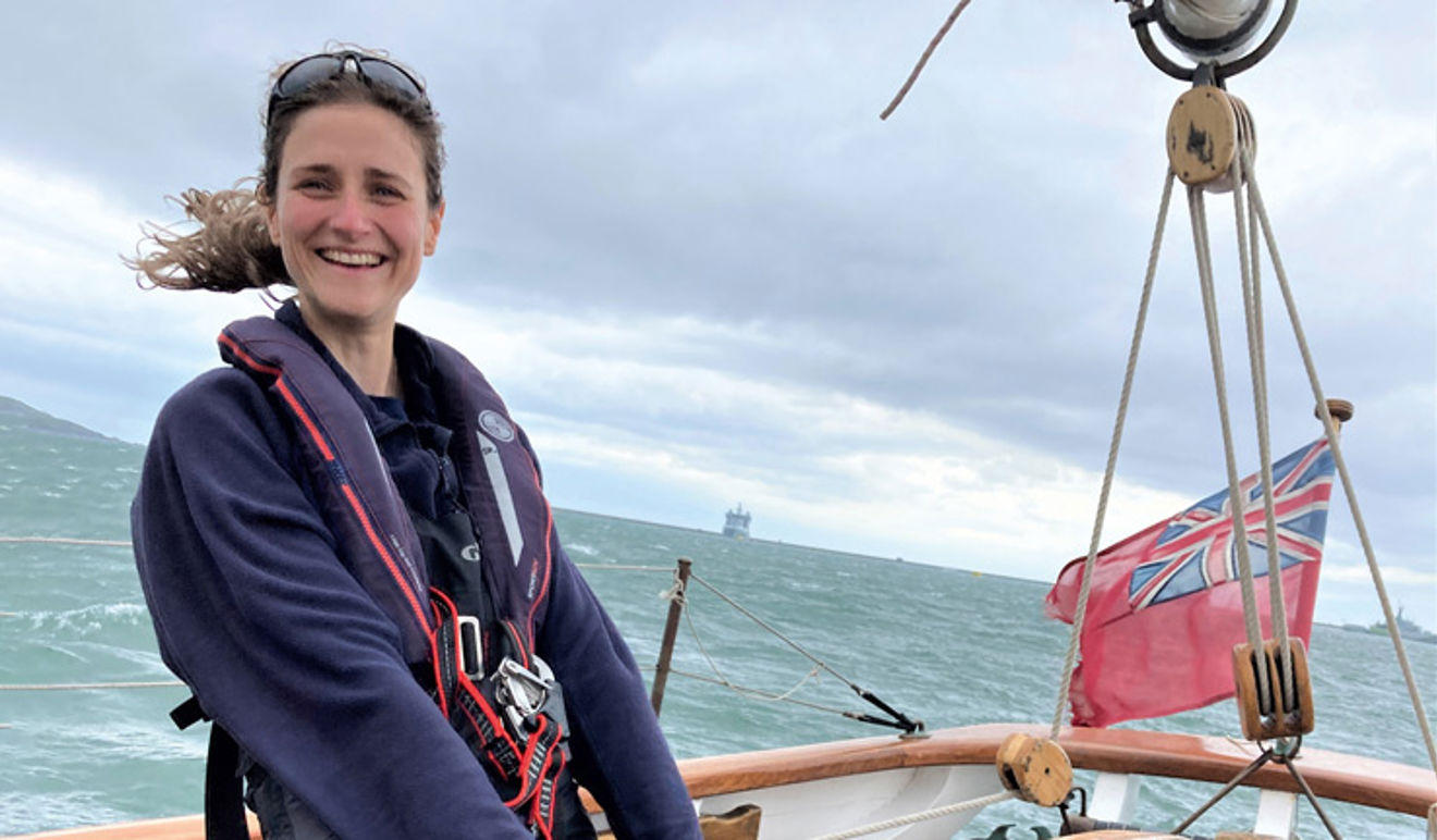 Close up shot of Laura McLachlan standing on a yacht smiling