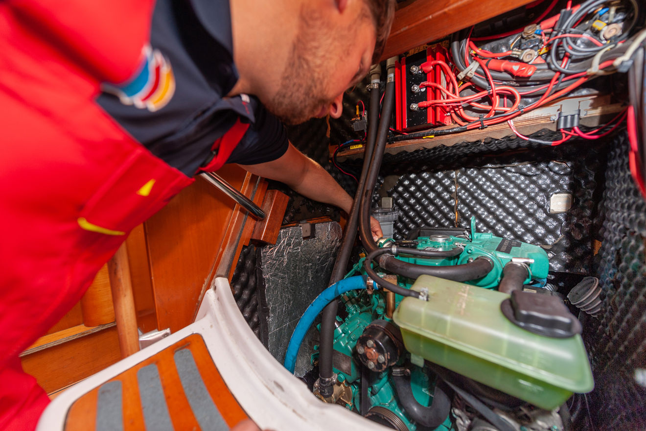 Person checking electrics of boat