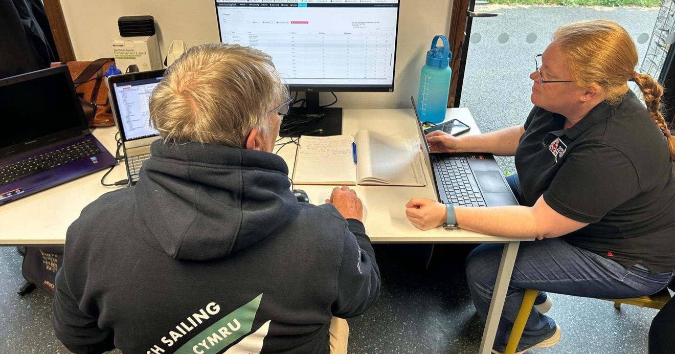 Huw processing results with another volunteer at a Welsh Sailing event