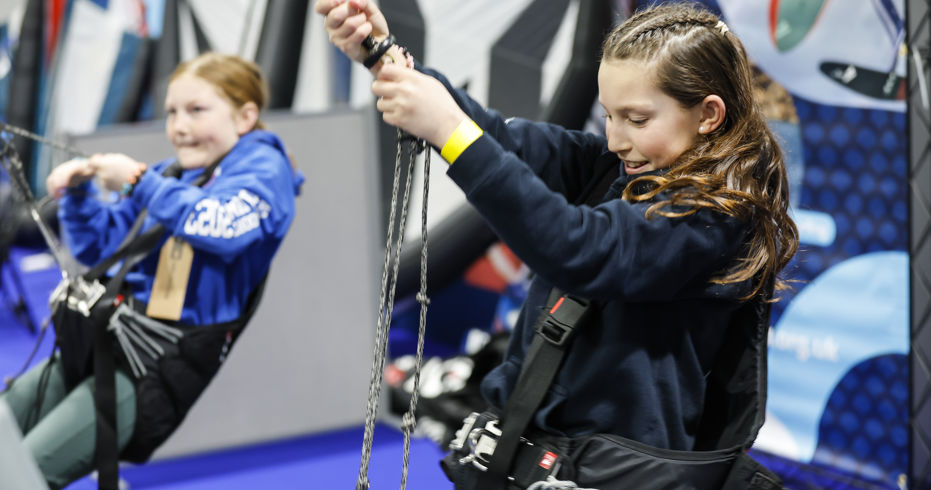 Mid shot of two young girls practicing their sailing skills at the Dinghy and Watersport Show