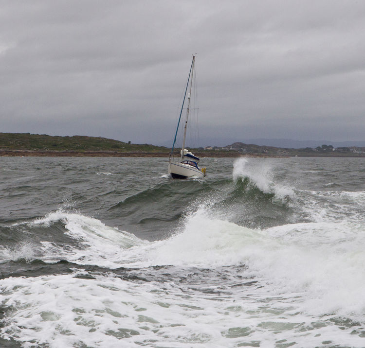 powerboat sailing through crashing waves
