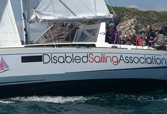 A group of people enjoying a day sailing with the Disabled Sailing Association in Torquay, Devon
